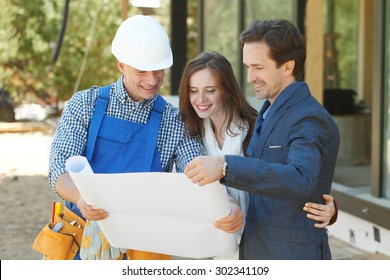 Foreman Shows House Design Plans To A Young Couple