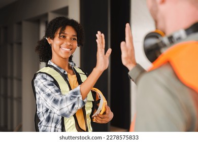 Foreman or Skillful worker team celebrate success at construction site. Industrial people and manufacturing labor concept - Powered by Shutterstock