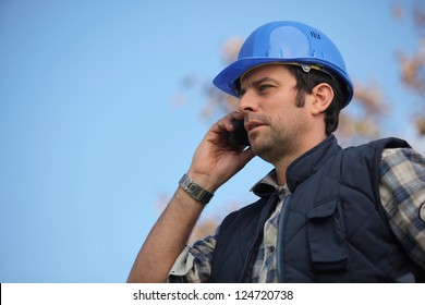 Foreman talking on his mobile phone
