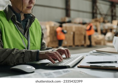Foreman typing document on computer
