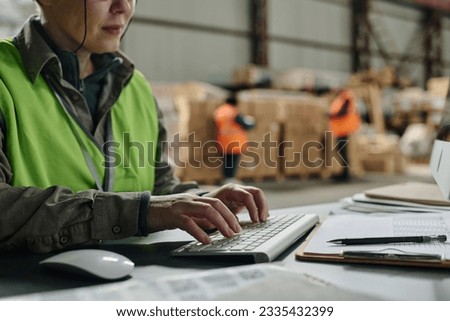 Foreman typing document on computer