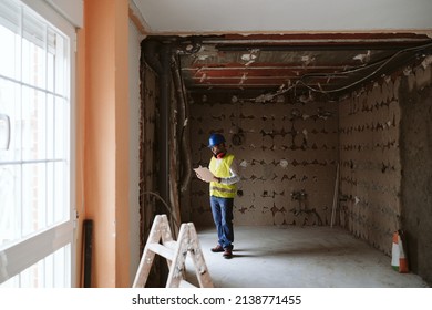 Foreman Or Unrecognizable Architect Working On Blueprints On Construction Site. Home Improvement