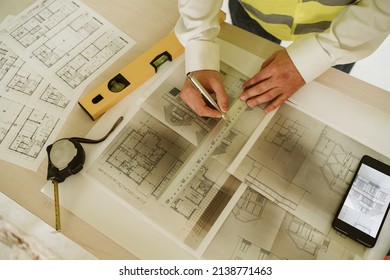 Foreman Or Unrecognizable Architect Working On Blueprints On Construction Site. Home Improvement