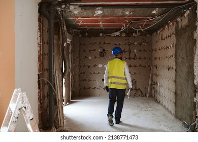 Foreman Or Unrecognizable Architect Working On Blueprints On Construction Site. Home Improvement