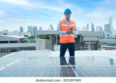 Foreman Is Using A Radio In The Area Of The Solar Panel. Foreman And Worker Maintaining Solar Energy Panel.