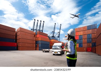 Foreman Woman control loading Containers box from Cargo freight ship for import export. - Powered by Shutterstock