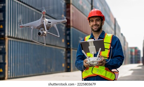 Foreman or worker use remote controller piloting drone at containers port for checking container. Foreman use remote control Drone with camera flying on container cargo ship at shipping port. - Shutterstock ID 2225803679