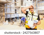 Foreman working outdoors condominium construction project exhausted from the hot weather and thirsty tired dizzy headache is dehydrated and wants to drink water suffer dehydration heatstroke.