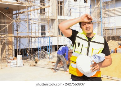 Foreman working outdoors condominium construction project exhausted from the hot weather and thirsty tired dizzy headache is dehydrated and wants to drink water suffer dehydration heatstroke. - Powered by Shutterstock