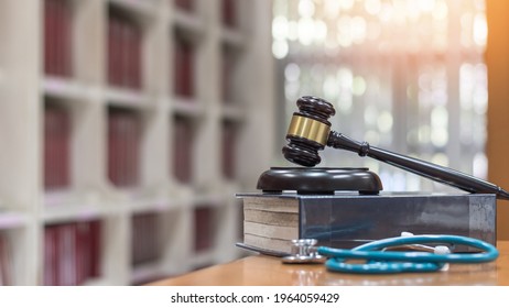 Forensic Medicine Science, Criminalistics Legal Investigation Or Medical Practice Justice Concept With Judge Gavel On Law Text Book For Criminal And Civil Laws In School Class Or Library