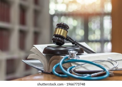 Forensic Medicine Science, Criminalistics Legal Investigation Or Medical Practice Justice Concept With Judge Gavel On Law Text Book For Criminal And Civil Laws In School Class Or Library