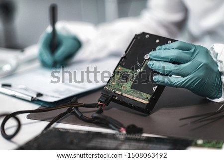 Forensic Science Investigator Examining Computer Hard Drive. Digital Forensic Science Concept.