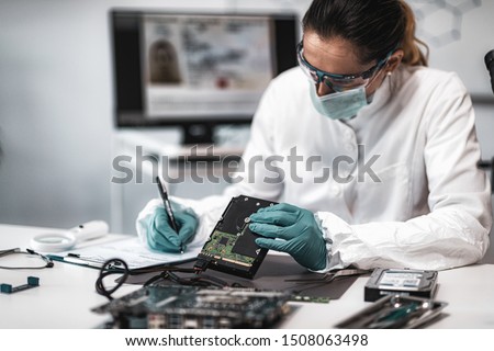 Forensic Science Investigator Examining Computer Hard Drive. Digital Forensic Science Concept.