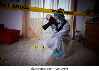 Forensics researcher photographing a blood  at a murder scene