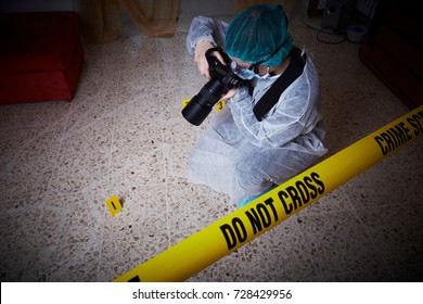 Forensics Researcher Photographing A Blood  At A Murder Scene