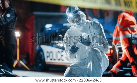 Forensics Team Putting Bullet Shell Found on Crime Scene in an Evidence Bag. Expert Using Proper Equipment to Protect a Clue and Fingerprints from Cross Contamination. He Sends it to Lab for Analysis