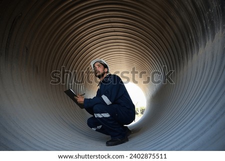 Foreperson working in side of  a huge Steel Pipe of tunnel foundation