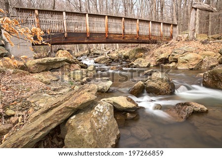 Forest bridge & water stream from Cunningham State Falls Park in Maryland, USA. HDR composite from multiple exposures.