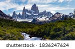 Forest crossed by the glacial river in El Chalten National Park, Argentina, Patagonia with Mount Fitz Roy and Cerro Torre in the background.