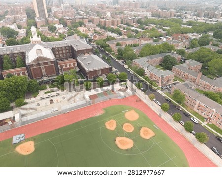 Forest fire haze over queens new york dewitt clinton high school building complex with athletic track and baseball fields in new york city, surrounded by residential buildings