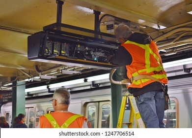 Forest Hills, NY/ USA- 11-27-18: New York City MTA Subway Worker Employee Repairing Train Station Platform