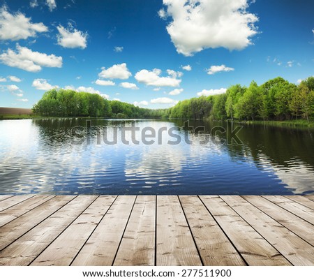 forest lake and wooden board background