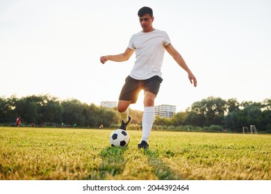 Forest on background. Young soccer player have training on the sportive field. - Powered by Shutterstock