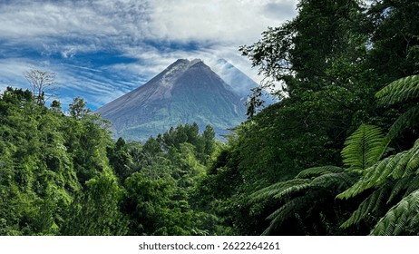 Forest path with mountain volcano view in tropical landscape. Lush greenery and beautiful sky, perfect for travel and exploration