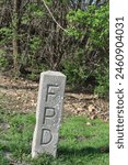 Forest Preserve District of Cook County concrete boundary marker at Wayside Woods in Morton Grove, Illinois