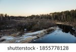 Forest river in begin of winter time