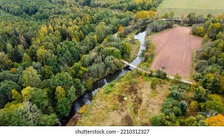 Forest And River At Sunset In Autumn. Aerial View Of Wildlife In Latvia, Europe