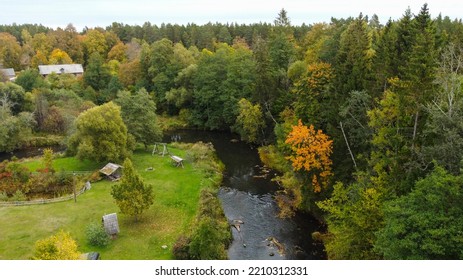 Forest And River At Sunset In Autumn. Aerial View Of Wildlife In Latvia, Europe