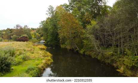 Forest And River At Sunset In Autumn. Aerial View Of Wildlife In Latvia, Europe