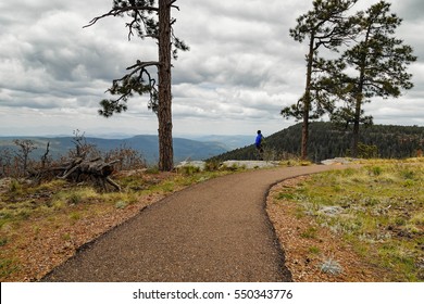 Forest Road/Hiking Trail By The Mogollon Rim, Payson Arizona/ A Calm Cloudy Day Landscape/ A Man Enjoying The Beauty Of Nature At The Distance