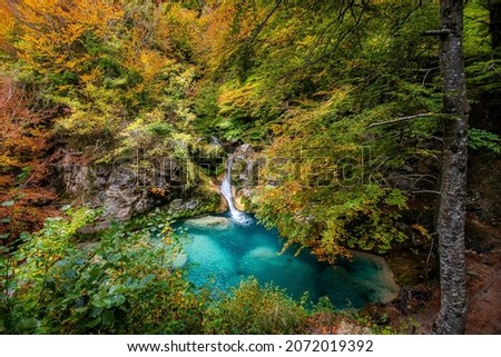 Forest turquoise blue lake with white marble stones and waterfalls in Nature Park Urbasa-Andia, Urederra.