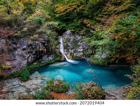 Forest turquoise blue lake with white marble stones and waterfalls in Nature Park Urbasa-Andia, Urederra.