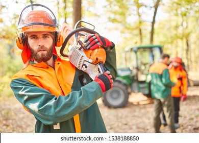 Forest worker or forest farmer as a woodcutter with chainsaw and in protective gear - Powered by Shutterstock