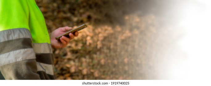 forest worker using smartphone in the forest