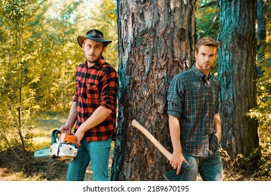 Foresters In The Forest. Hipsters On Serious Face Carries Axe. Lumberjack Brutal Holds Axe. Brutal Lumberjack Concept.