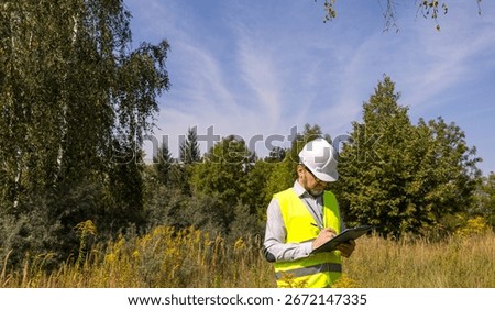 Forestry inspector studying the condition of trees in the forest. Work Ecologist. Eco control. Conducting environmental monitoring.	