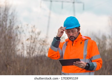 Forestry technician using digital tablet in forest to collect the data for analysis