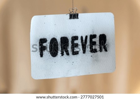Forever word spray painted on textured paper representing commitment and timelessness