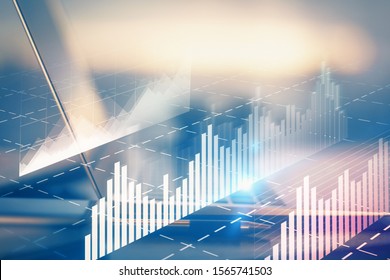 Forex Graph Hologram On Table With Computer Background. Multi Exposure. Concept Of Financial Markets.