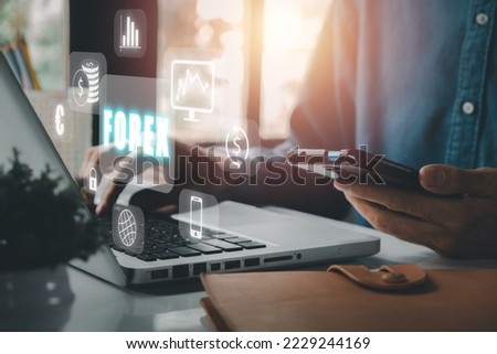 Forex trading, Young man using smartphone and laptopcomputer with Forex icon on VR screen on desk, Online investment. Business, internet and technology concept.