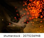 Forge fire in furnace. Blacksmith tempers a steel product in a stove. Smithy forging for hardening and heating iron. Blacksmith stove