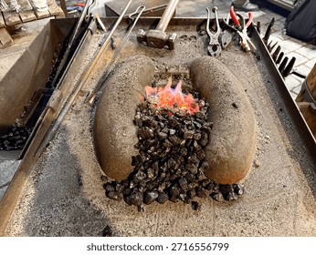 Forge with flames between the stone refractory sides