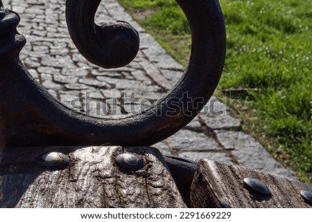 forged details of wooden parkbench close-up