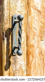 Forged Handmade Door Handle On The Wooden Door Close Up
