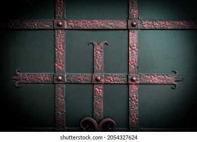 Forged metal strips with a red tint on the wrought iron gate