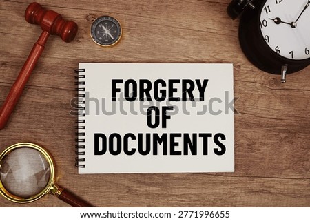 Forgery of Documents message written on notepad with alarm clock, wood gavel and magnifying glass flat lay on wooden background